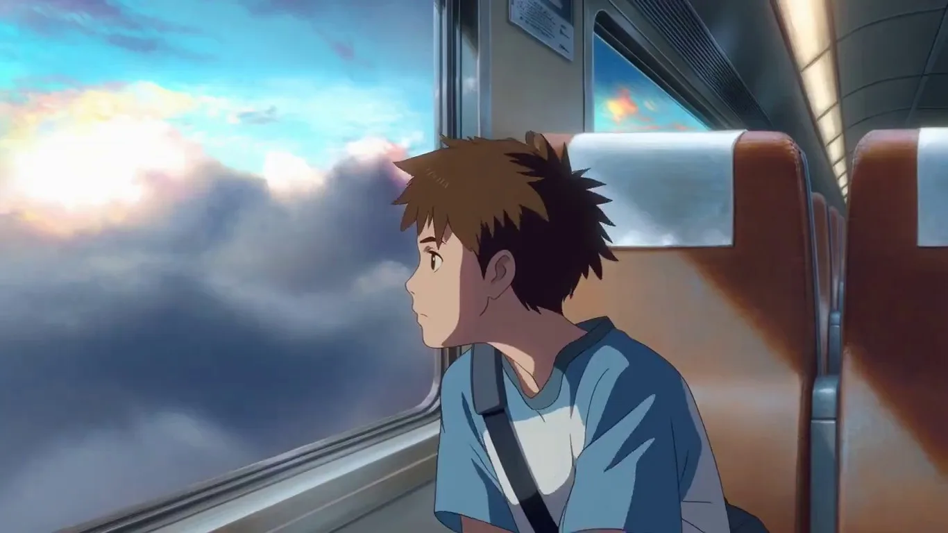 A boy sits inside a train